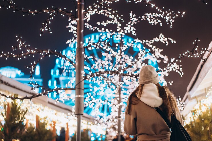 Girl posing against background decorated trees